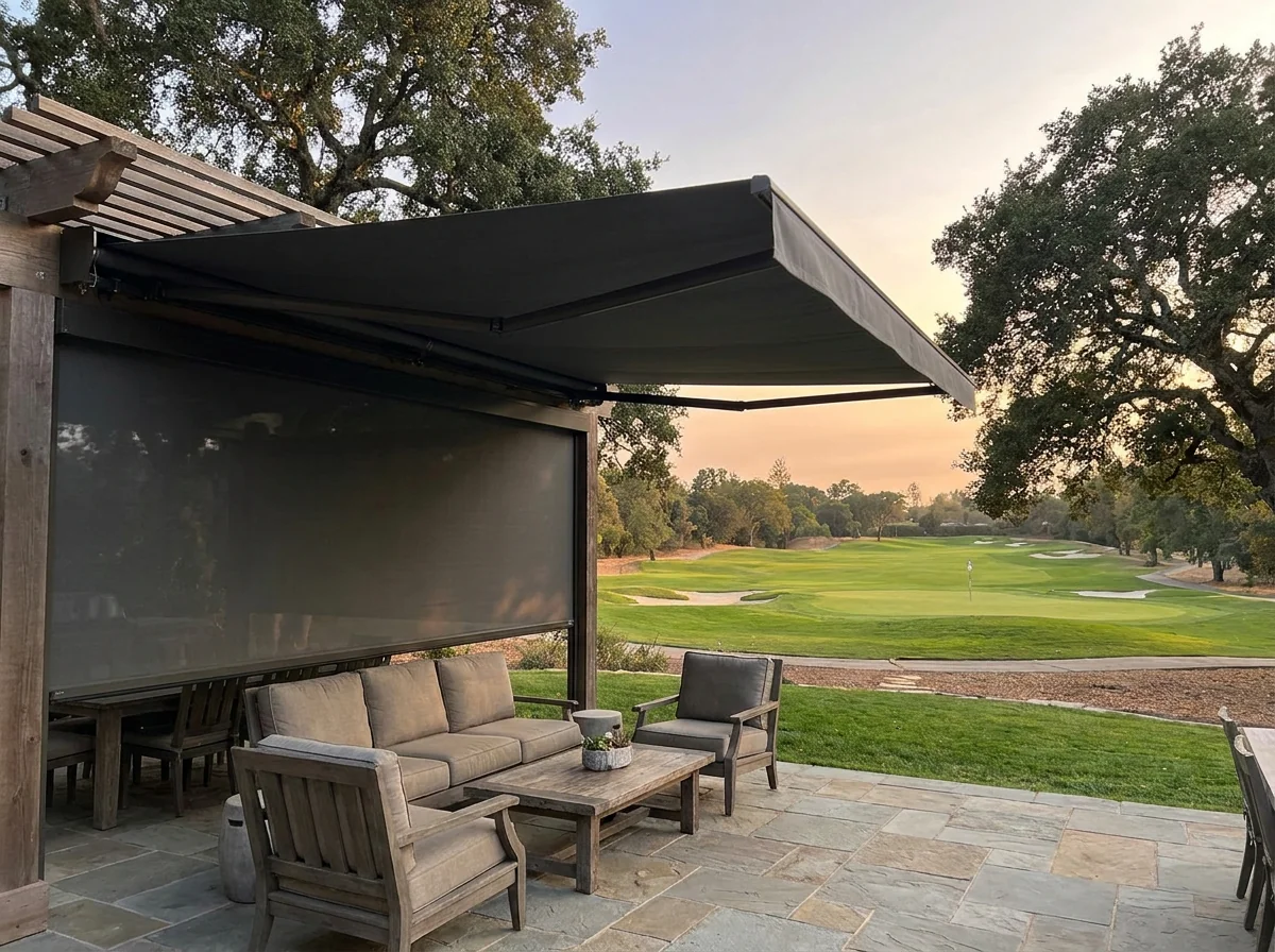 Covered patio with a folding-arm awning and zip screen shading the seating area, golf course beyond